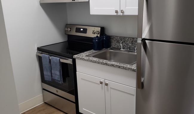 a kitchen with white cabinets