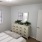 a bedroom with a bed and dresser
