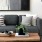 a couch with a coffee table with a plant and decor on it