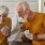 a man and woman sitting at a table playing cards